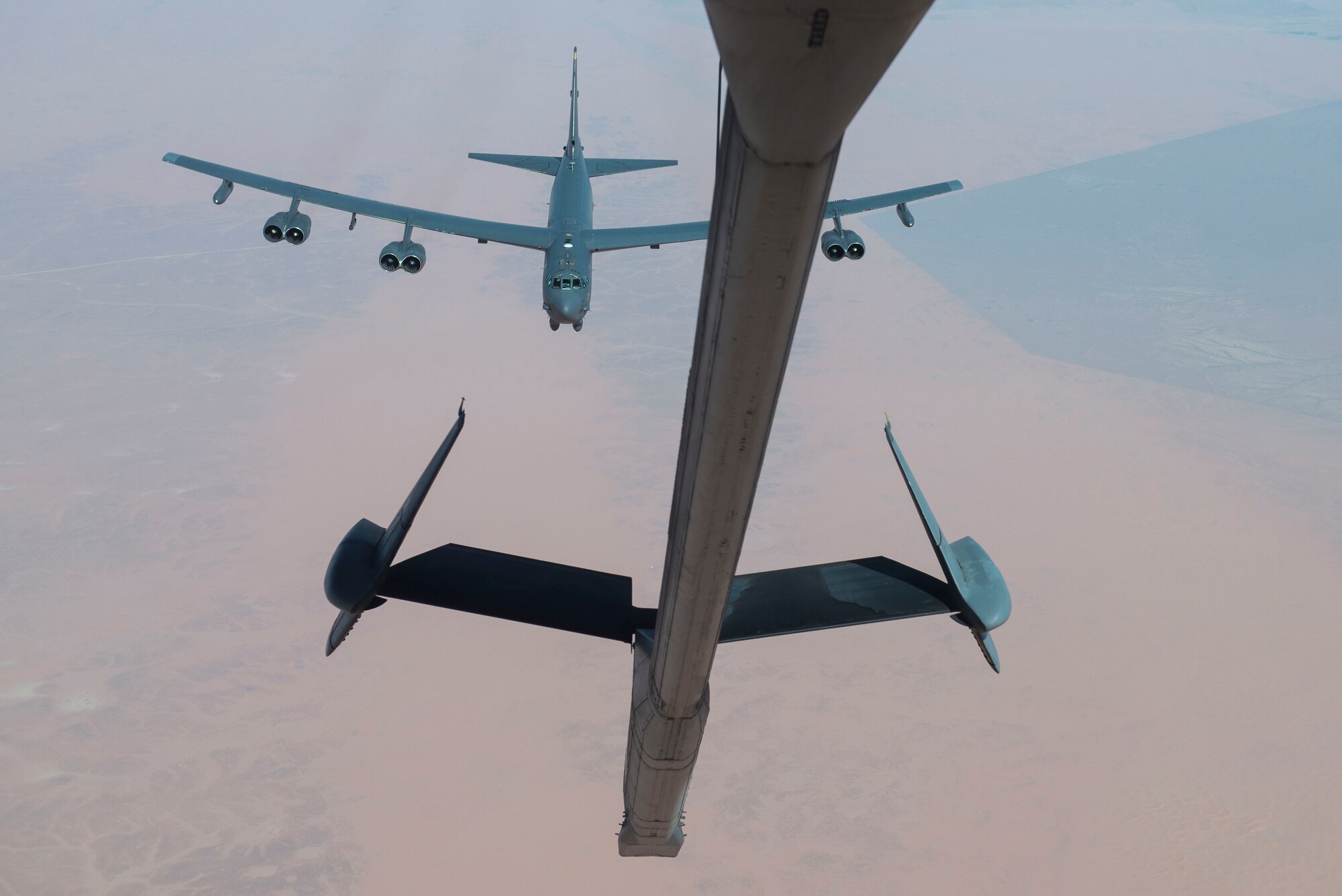 A U.S. Air Force B-52 Stratofortress assigned to the 5th Bomb Wing approaches a KC-10 Extender assigned to the 908th Expeditionary Air Refueling Squadron in preparation for aerial refueling over the U.S. Central Command (CENTCOM) area of responsibility (AOR), March 7, 2021.