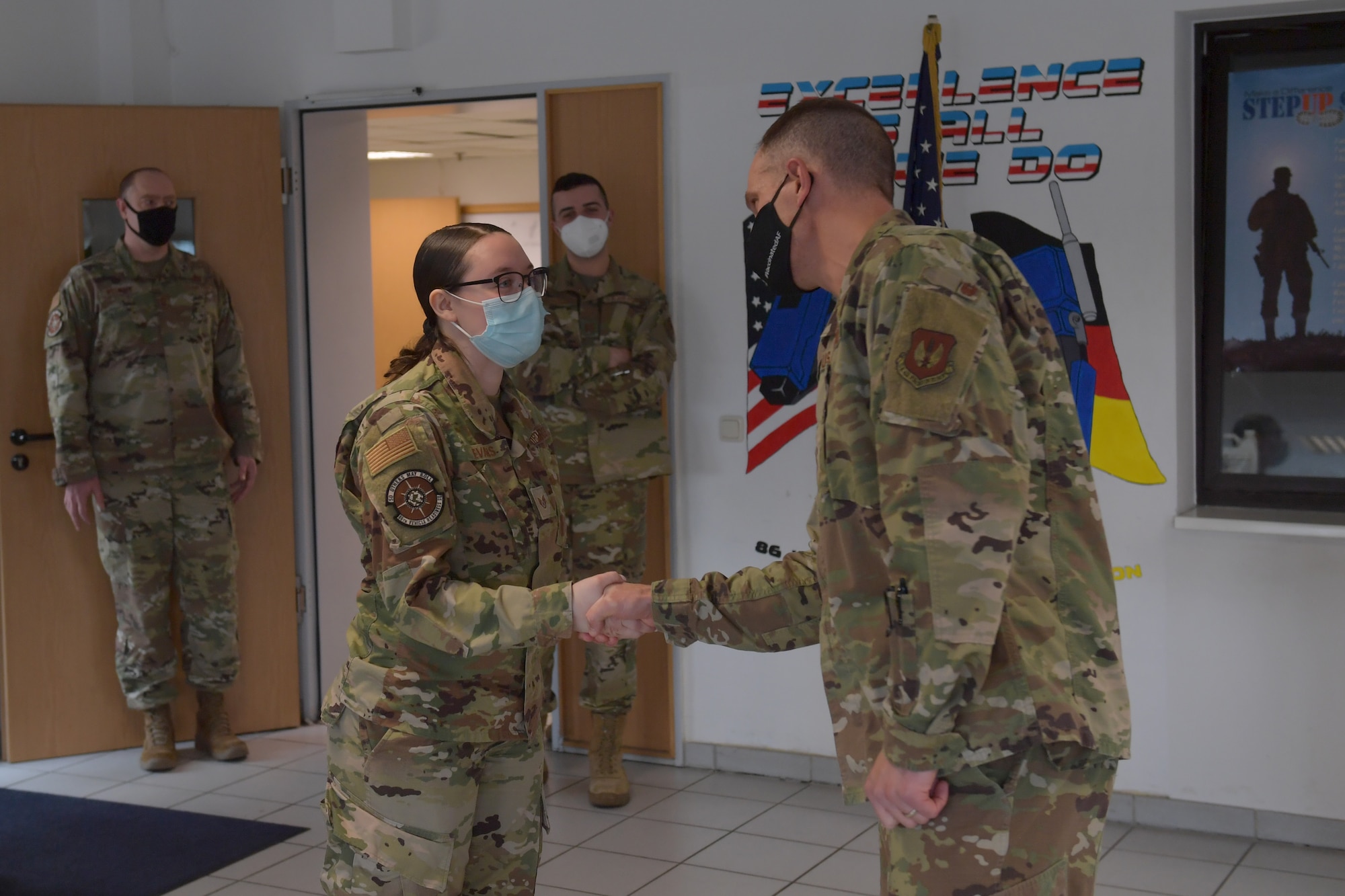 Airmen standing in a room.