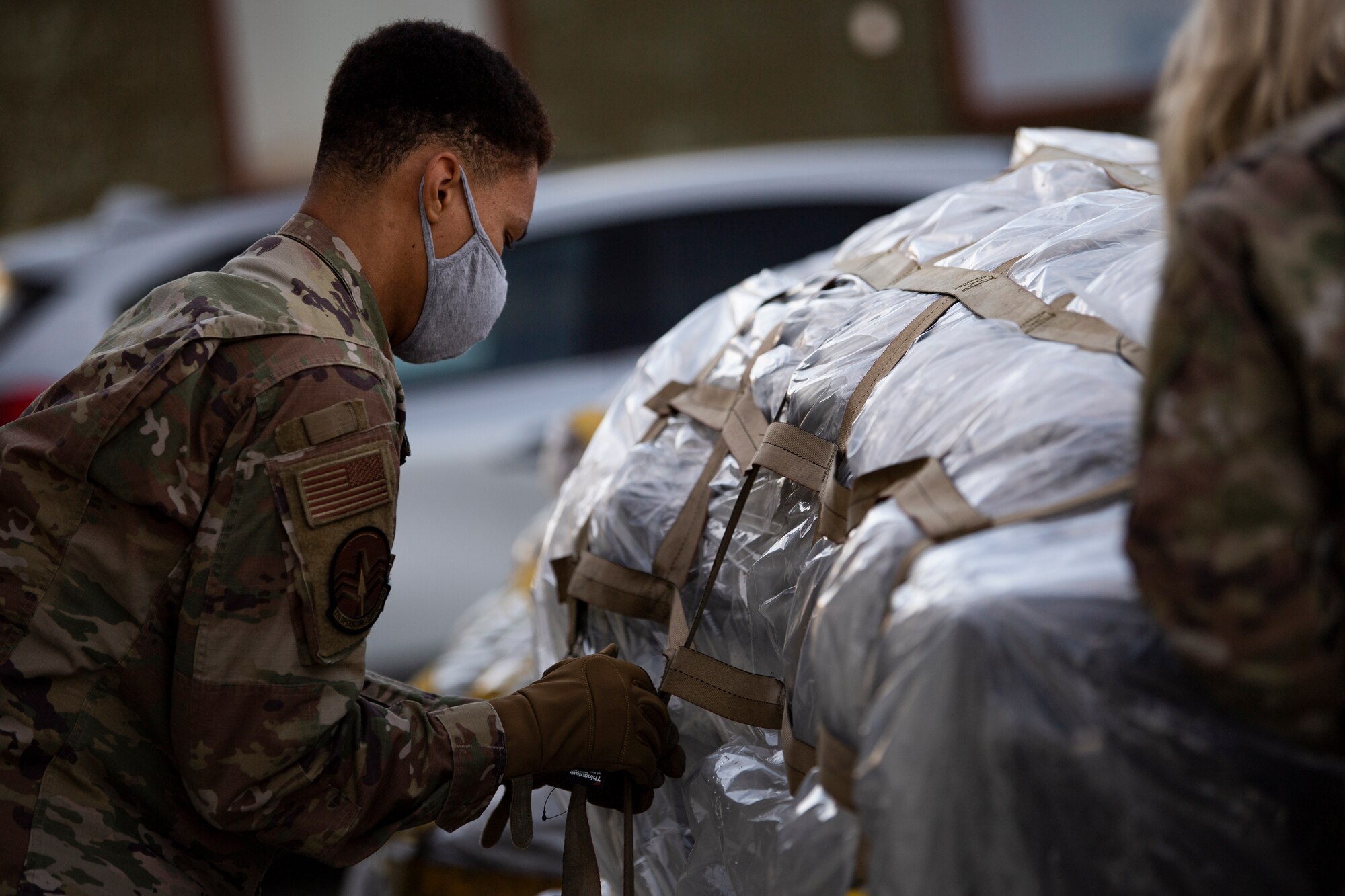 An aircrew flight equipment craftsman, assigned to the 9th Expeditionary Bomb Squadron, disassembles packaged cargo at Orland Air Force Station, Norway, Feb. 23, 2021. A variety of mission support cargo was transported to Ørland Air Force Station for a Bomber Task Force Europe deployment. BTFs give Airmen the opportunity to integrate and train with ally and partner forces. (U.S. Air Force photo by Airman 1st Class Colin Hollowell)