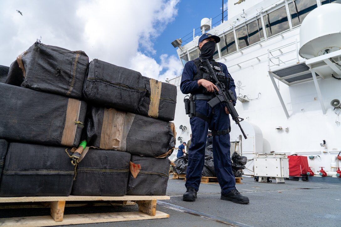 The crew of the Coast Guard Cutter Bertholf (WMSL-750) offloads approximately 7,500 pounds of seized cocaine and marijuana in San Diego, March 20, 2021.