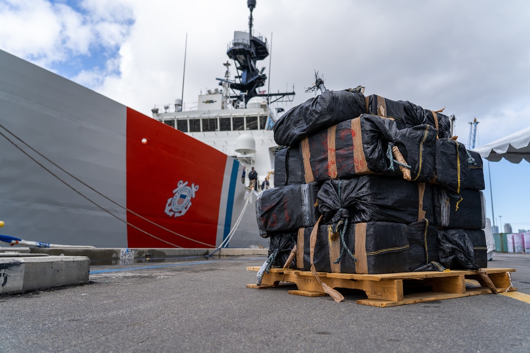 The crew of the Coast Guard Cutter Bertholf (WMSL-750) offloads approximately 7,500 pounds of seized cocaine and marijuana in San Diego, March 20, 2021.