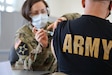 Master Sgt. Carolyn Lange, U.S. Army nurse and recruiter, administers a COVID-19 vaccine at Fort Meade, Maryland on Feb. 26.