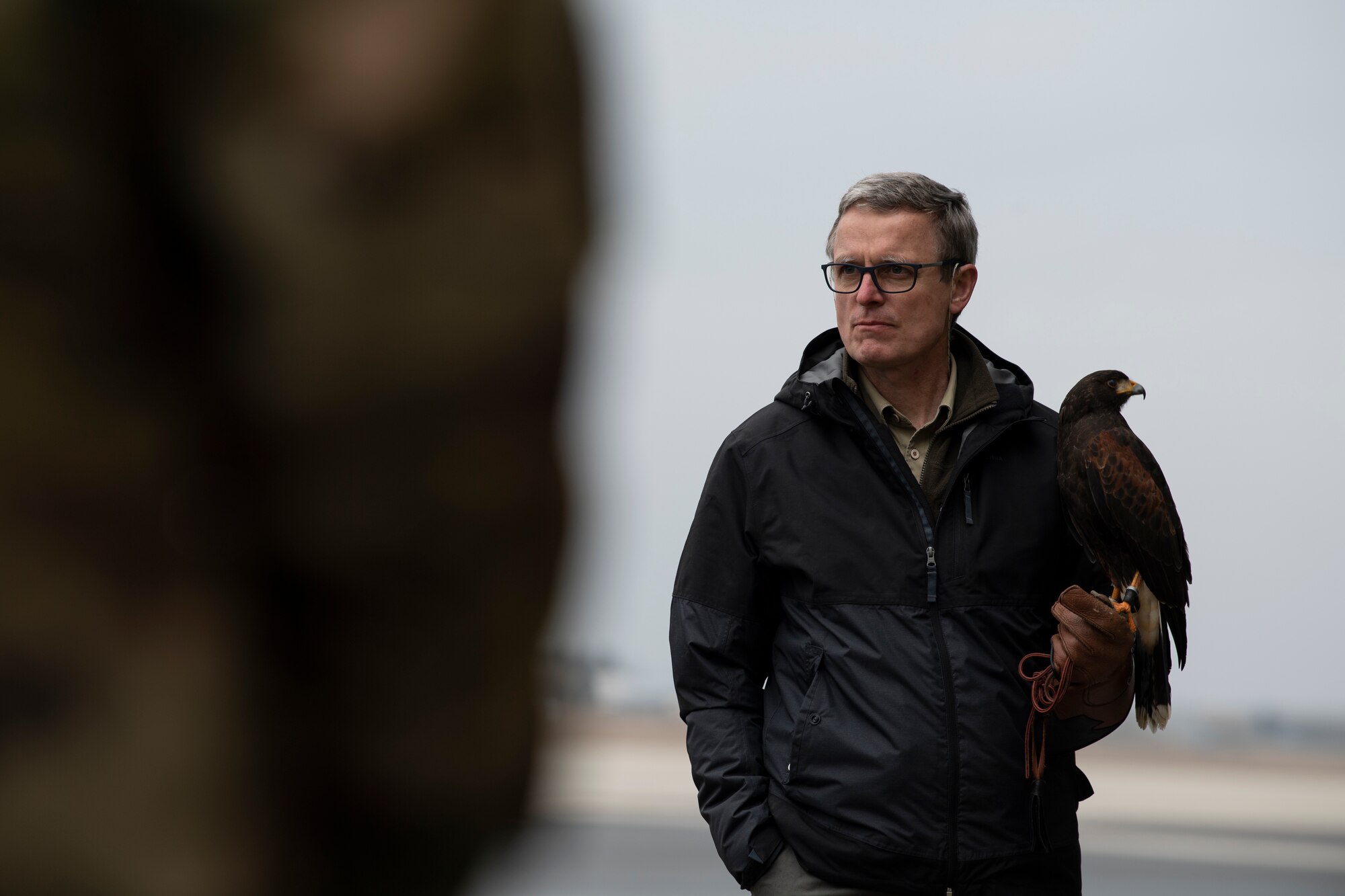 Jens Fleer, 52nd Fighter Wing base falconer, holds his hawk, Jack, as he speaks to U.S. Air Force members of the 726th Air Mobility Squadron during a Bird and Wildlife Aircraft Strike Hazard (BASH) briefing at the 726th AMS on Spangdahlem Air Base, Germany, March 5, 2021.