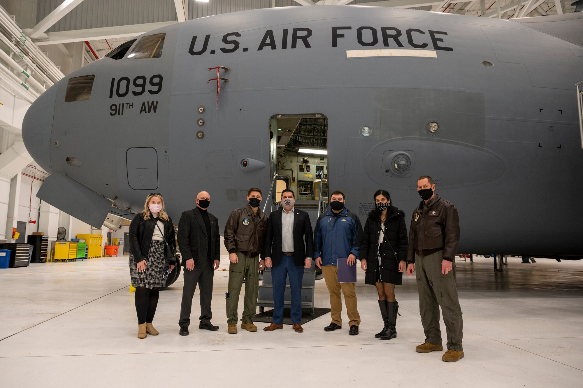 911th Airlift Wing leadership, Pennsylvania State Sen. Devlin Robinson and his staff take advantage of a photo opportunity in front of a C-17 Globemaster III inside the new two-bay hangar at the Pittsburgh International Airport Air Reserve Station, Pennsylvania, Feb. 26, 2021.