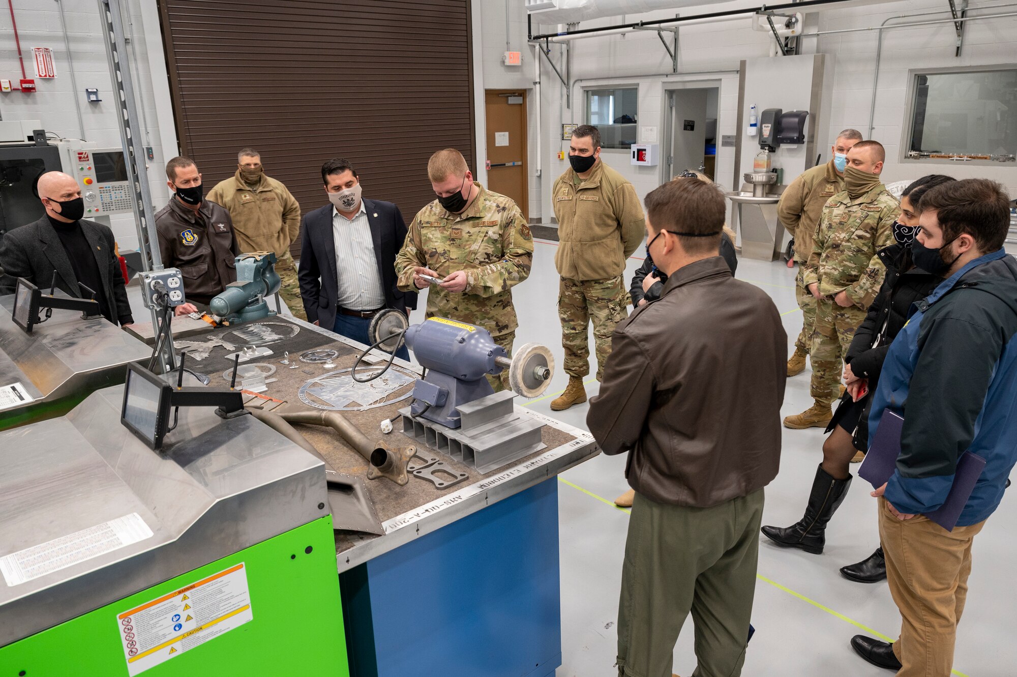 Staff Sgt. Adam Kitta, 911th Maintenance Squadron metals technician, explains the process and benefits of metal fabrication to Pennsylvania State Sen. Devlin Robinson at the Pittsburgh International Airport Air Reserve Station, Pennsylvania, Feb. 26, 2021.