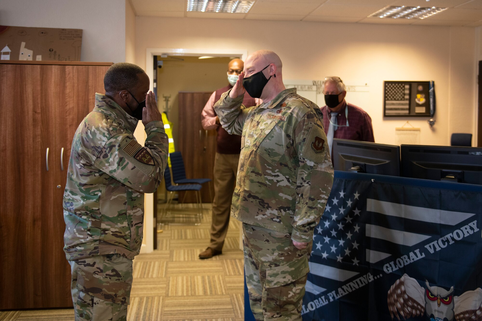 U.S. Air Force Brig. Gen. Ronald E. Jolly Sr., left, U.S. Air Forces in Europe and Air Forces Africa logistics, engineering and force protection director, recognizes Master Sgt. Dustin Jarvis, 501st Combat Support Wing logistics superintendent, for his work during a visit to the 501st CSW Logistics team at Royal Air Force Alconbury, England, March 10, 2021. The 501st CSW hosted an immersion tour for Jolly and his leadership team, demonstrating the mission set and capabilities of several organizations including the security forces, logistics readiness and civil engineer squadrons. (U.S. Air Force photo by Senior Airman Jennifer Zima)