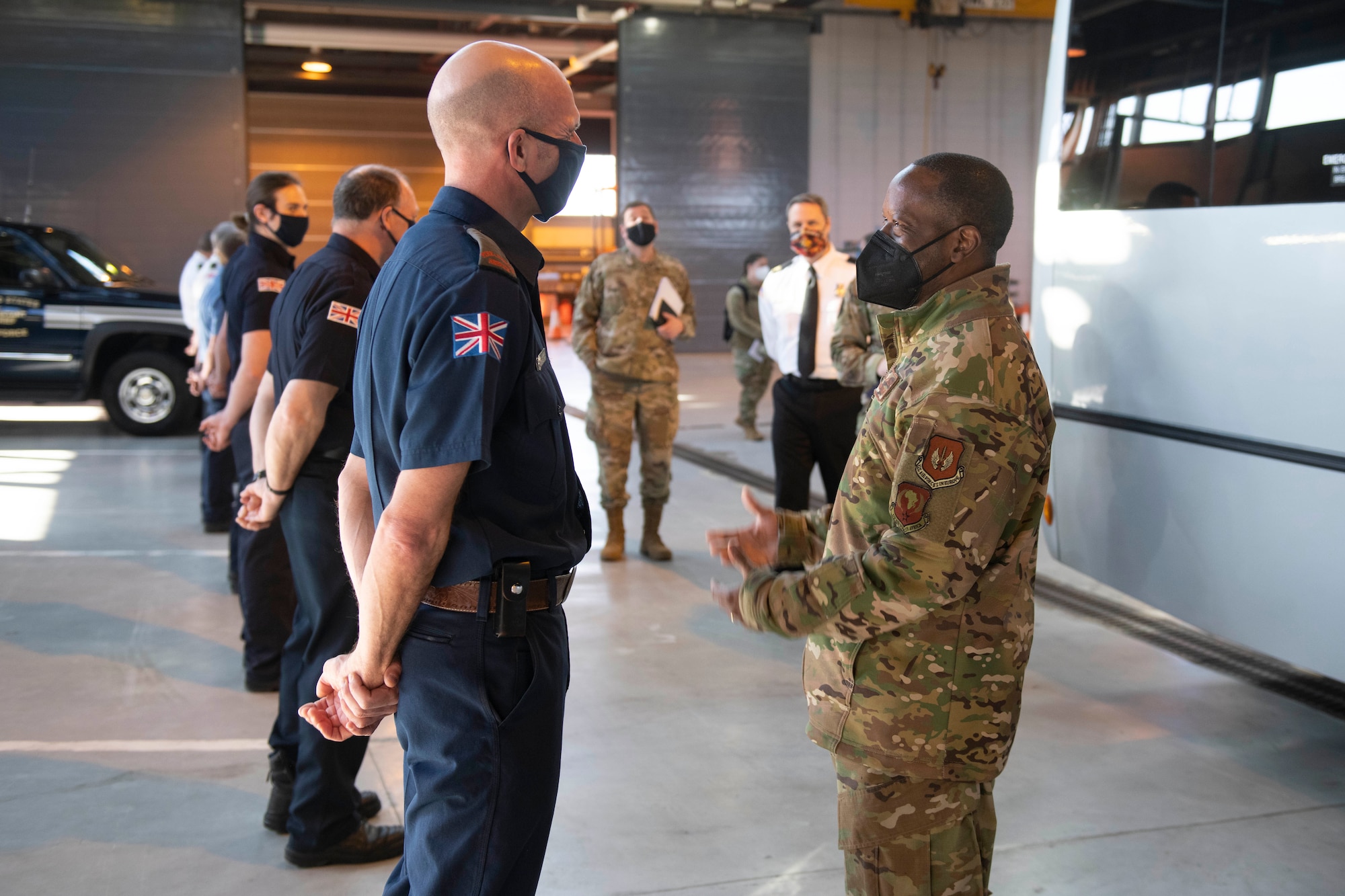 U.S. Air Force Brig. Gen. Ronald E. Jolly Sr., right, U.S. Air Forces in Europe and Air Forces Africa logistics, engineering and force protection director, greets a 423rd Civil Engineer  Squadron firefighter at Royal Air Force Alconbury, England, March 10, 2021. The 501st CSW hosted an immersion tour for Jolly and his leadership team, demonstrating the mission set and capabilities of several organizations including the security forces, logistics readiness and civil engineer squadrons. (U.S. Air Force photo by Senior Airman Jennifer Zima)