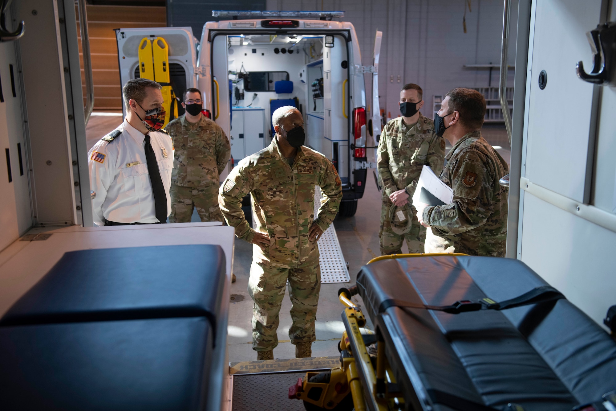 U.S. Air Force Col. Kurt Wendt, left, 501st Combat Support Wing commander, shares with Brig. Gen. Ronald E. Jolly Sr., center, U.S. Air Forces in Europe and Air Forces Africa logistics, engineering and force protection director, his experiences of working with the 423rd Civil Engineer  Squadron fire department at Royal Air Force Alconbury, England, March 10, 2021. The 501st CSW hosted an immersion tour for Jolly and his leadership team, demonstrating the mission set and capabilities of several organizations including the security forces, logistics readiness and civil engineer squadrons. (U.S. Air Force photo by Senior Airman Jennifer Zima)