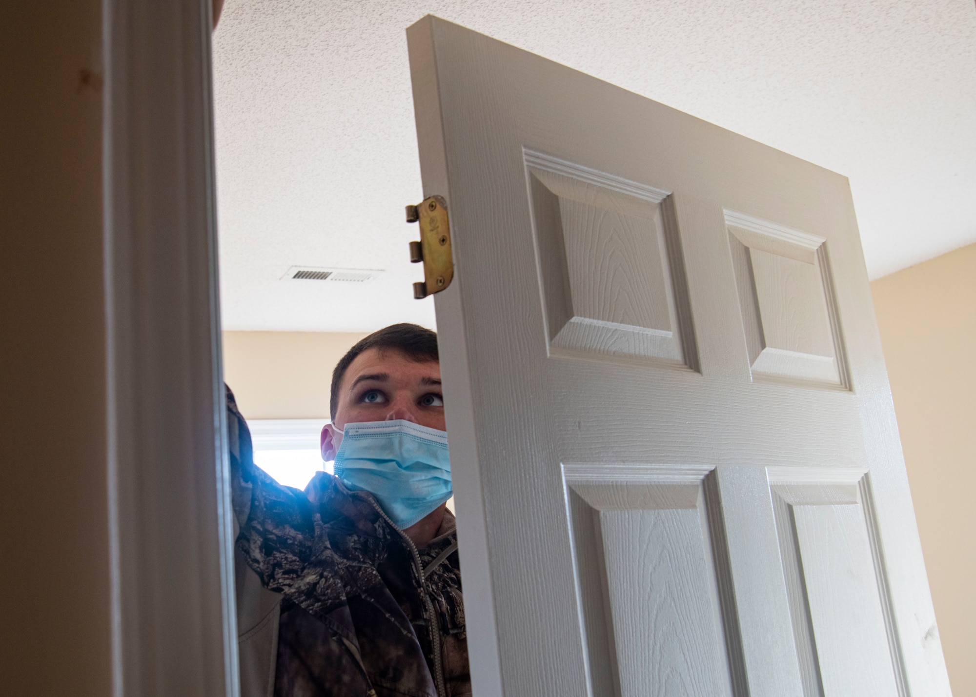 Photo of Airman putting together a door