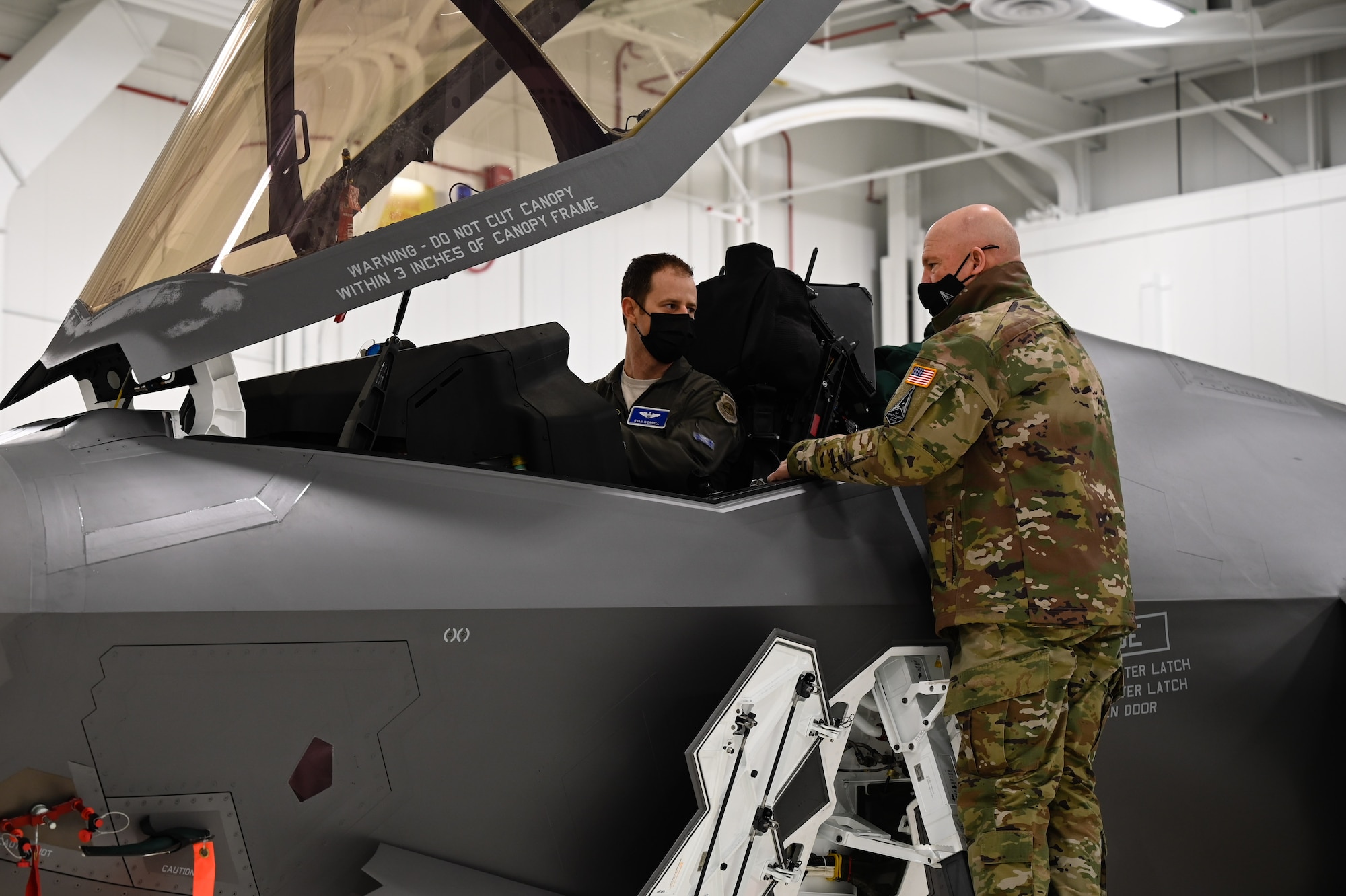 U.S. Air Force Lt. Col. Ryan Worrell, the 355th Fighter Squadron director of operations, shows U.S. Space Force Gen. John W. “Jay” Raymond, Chief of Space Operations, the inside of an F-35A Lightning II cockpit on Eielson Air Force Base, Alaska, March 10, 2021.