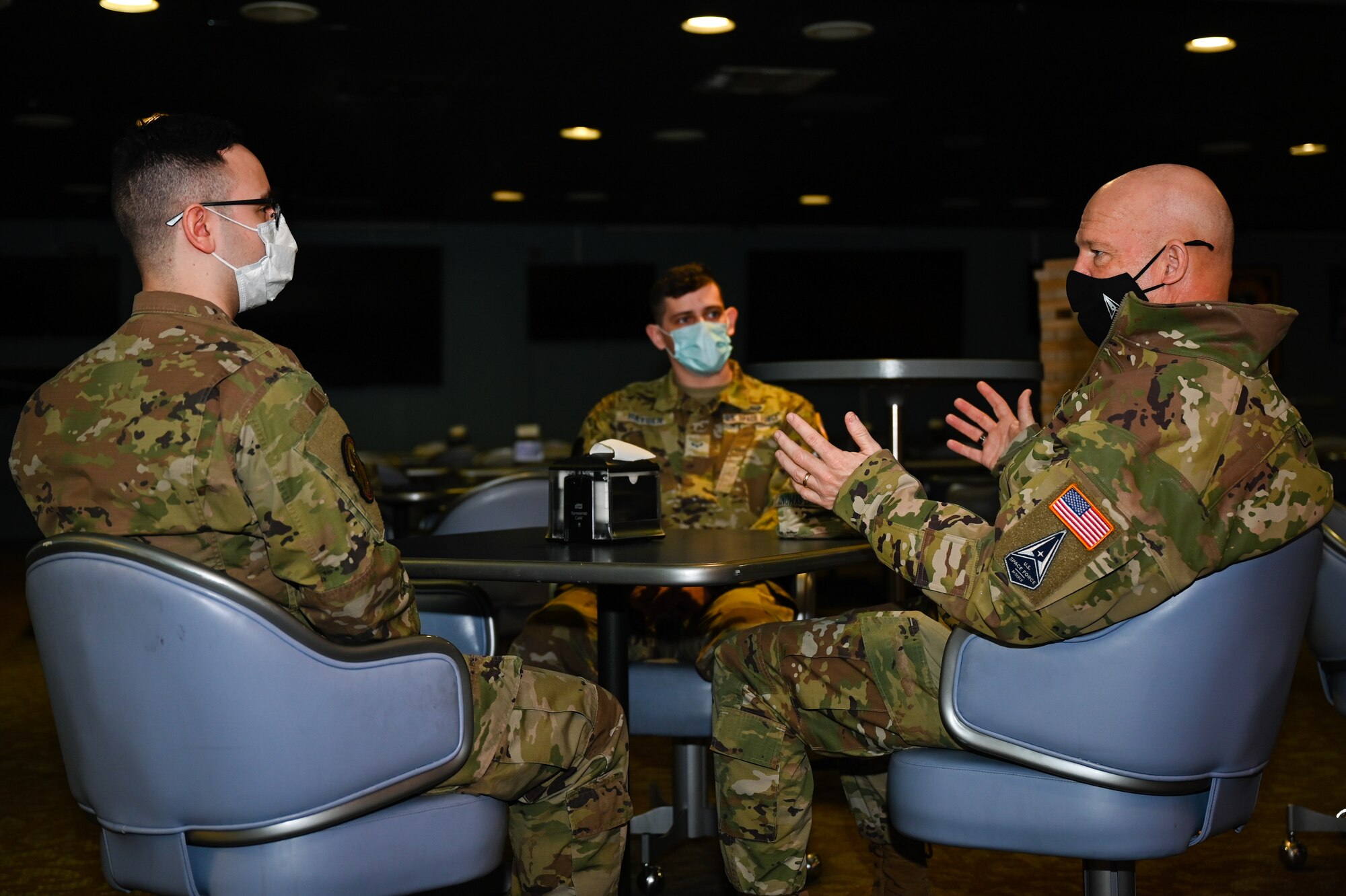 U.S. Space Force Gen. John W. “Jay” Raymond, Chief of Space Operations, talks to Sgt. Jacob Varner, a 354th Communications Squadron vulnerability hunt specialist, left, and Specialist 3 Richard Hayden, a 354th Range Squadron radio frequency transmission journeyman, on Eielson Air Force Base, Alaska, March 10, 2021.