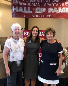 Three women stand together