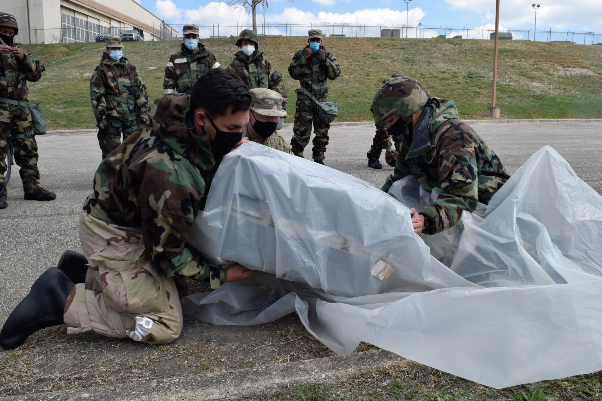 Reserve Citizen Airmen in the 433rd Airlift Wing work together to cover cargo March 6, 2021, at Joint Base San Antonio-Lackland, Texas. Almost 50 Airmen from five different units in the wing trained, operated, and gained experience in readiness together. (U.S. Air Force photo by Senior Airman Brittany Wich)