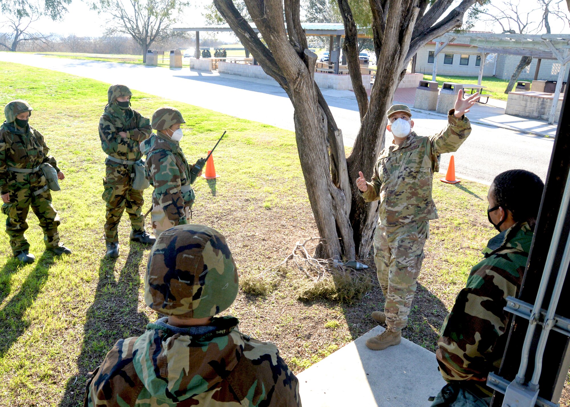 Tech. Sgt. William Bonner, 74th Aerial Port Squadron, instructs Reserve Citizen Airmen in the 433rd Airlift Wing during a simulated post-attack reconnaissance sweep March 6, 2021, at Joint Base San Antonio-Lackland, Texas. The Airmen received real-world training and practice in wearing different levels of mission-oriented protective posture gear, while performing sweeps and transporting cargo. (U.S. Air Force photo by Tech. Sgt. Samantha Mathison)