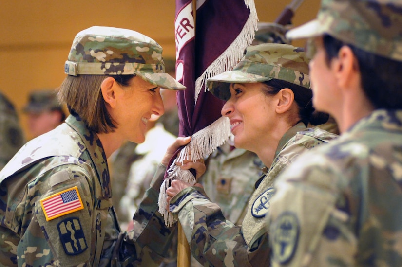 Two woman hold a flag