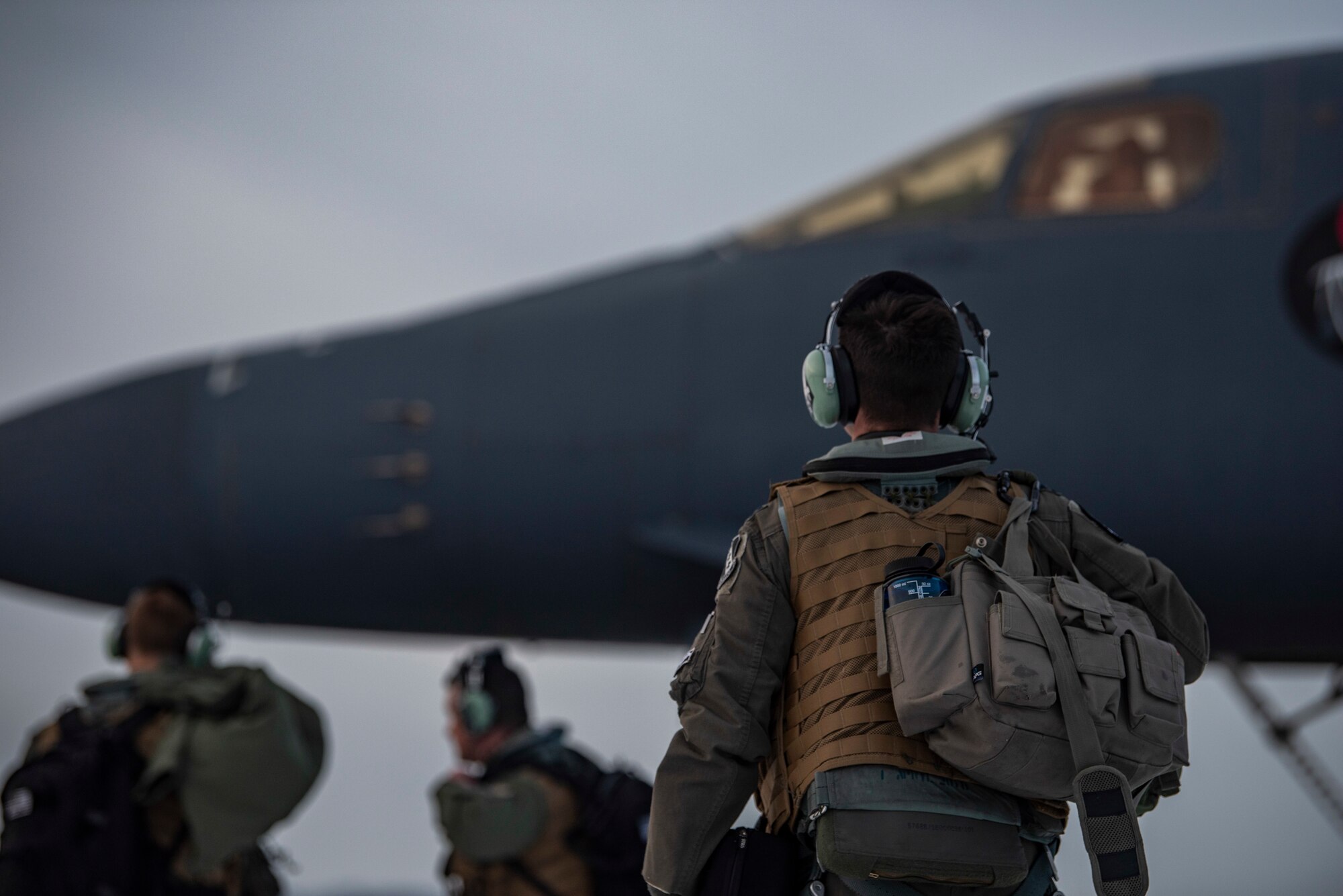 Aircrew assigned to the 9th Expeditionary Bomb Squadron prepare to board a B-1B Lancer on the flightline at Ørland Air Force Station, Norway, March 8, 2021. The aircrew participated in the Bomber Task Force Europe training mission, Agile Condor, where they conducted a warm pit ground refueling. (U.S. Air Force photo by Airman 1st Class Colin Hollowell)