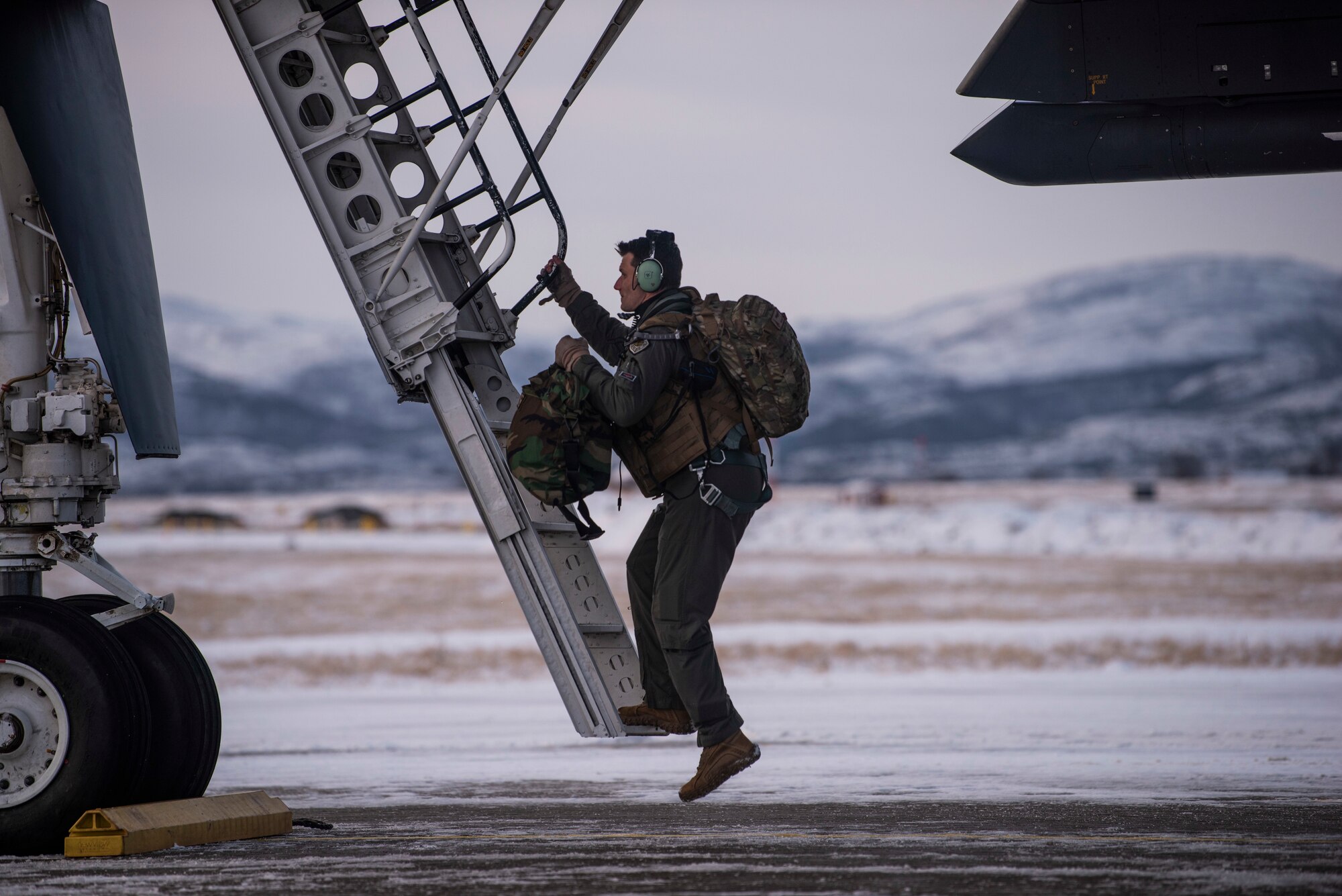 A 9th Expeditionary Bomb Squadron pilot boards a B-1B bomber at Ørland Air Force Station, Norway, March 8, 2020. The aircrew participated in the Bomber Task Force Europe training mission, Agile Condor, where they flew from Ørland AFS to Bodø AFS, Norway to conduct warm pit ground refueling. Operating the B-1 out of locations that typically do not support a bomber presence demonstrates strategic Agile Combat Employment capabilities. (U.S. Air Force photo by Airman 1st Class Colin Hollowell)