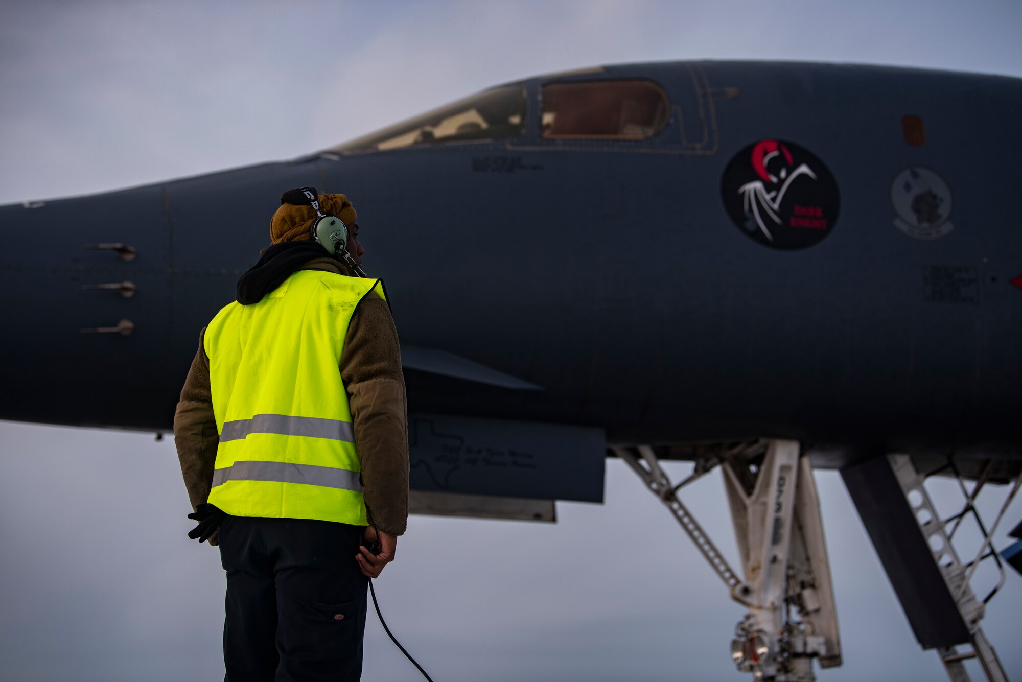 A crew chief assigned to the 9th Expeditionary Bomb Squadron communicates with B-1B Lancer aircrew prior to take-off at Ørland Air Force Base, Norway, March 8, 2021. The 9th Expeditionary Bomb Squadron deployed to Ørland AFS in support of a Bomber Task Force Europe deployment to conduct a series of training missions while integrating with NATO allies and partner forces. (U.S. Air Force photo by Airman 1st Class Colin Hollowell)