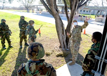 Tech. Sgt. William Bonner, 74th Aerial Port Squadron, instructs Reserve Citizen Airmen in the 433rd Airlift Wing during a simulated post attack reconnaissance sweep March 6, 2021, at Joint Base San Antonio-Lackland, Texas. The Airmen received real world training and practice in wearing different levels of mission-oriented protective posture gear, while performing sweeps and transporting cargo. (U.S. Air Force photo by Tech. Sgt. Samantha Mathison)