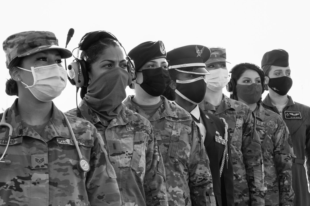 Women in uniform who hold a range of jobs in the Air Force stand in line.