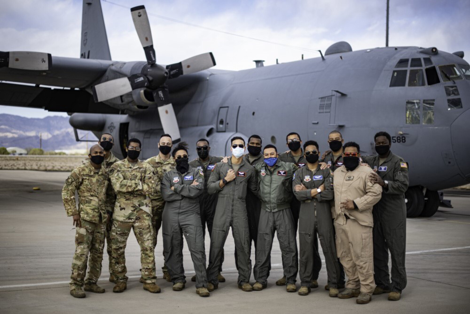 Members of the 41st Electronic Combat Squadron "Black Heritage Flight" pose for a photo in front of an EC-130 Compass Call at Davis-Monthan Air Force Base, Arizona on Feb. 17, 2021.