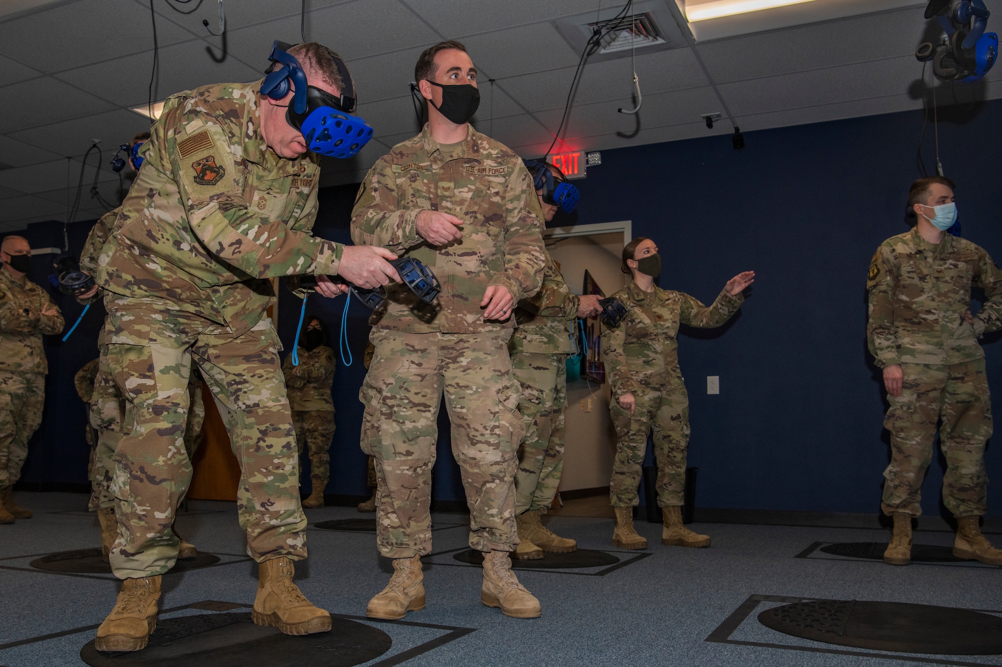 Staff Sgt. Christopher Clinton, 317th Maintenance Group noncommissioned officer in charge of the virtual reality lab, aids Chief Master Sgt. Chad Bickley, 18th Air Force command chief, with virtual reality controls at Dyess Air Force Base, Texas, Mar. 3, 2021.