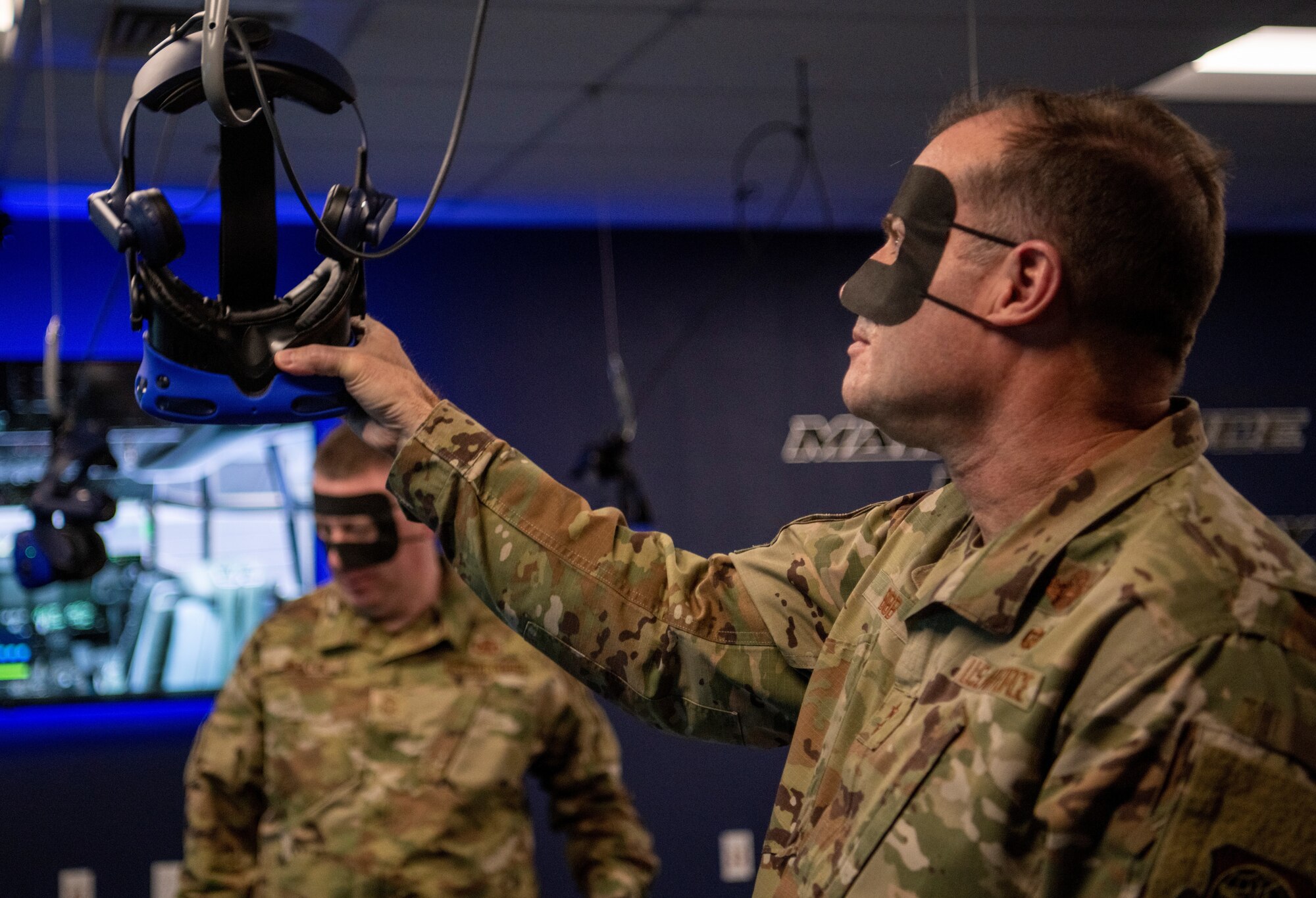 Maj. Gen. Thad Bibb, 18th Air Force commander, hangs up a virtual reality headset at Dyess Air Force Base, Texas, Mar. 3, 2021.