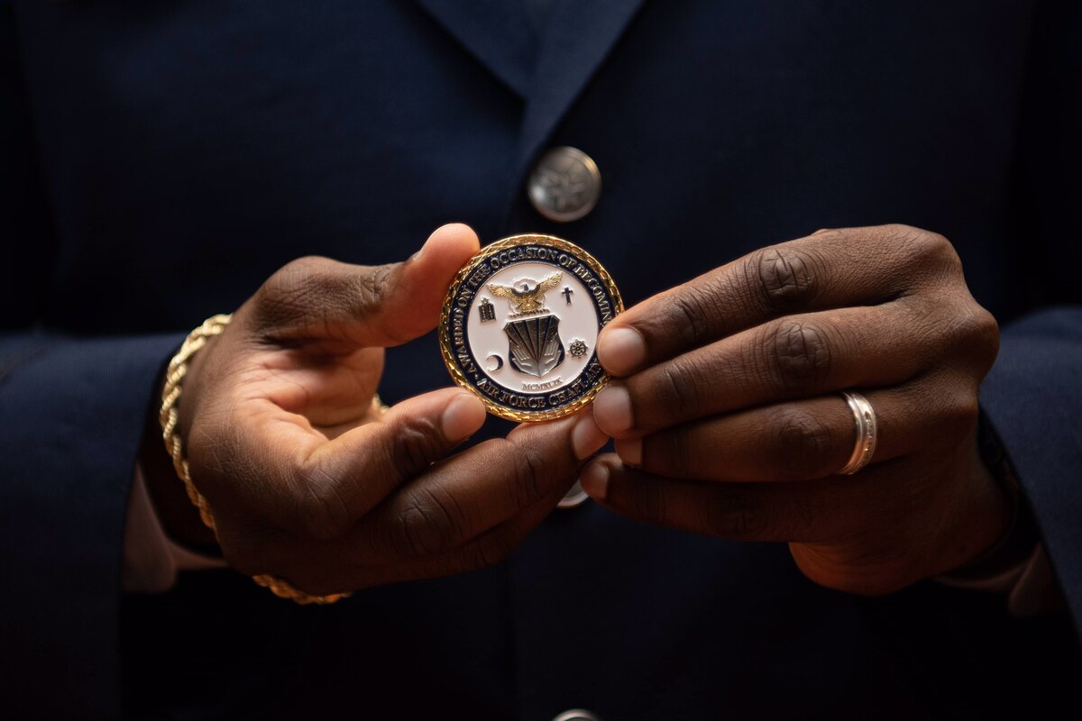 A graduate of the Air Force Chaplain Corps College holds their graduation coin. (Courtesy photo)