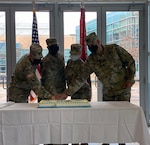 CRDAMC's Senior Enlisted Advisor Command Sgt. Maj. Elvin Medina (right) and Command Sgt. Maj Todd Garner flank the most senior and junior enlisted medical Soldiers in a traditional cake cutting ceremony during the CRDAMC's Army Medical Department Enlisted Corps' 134th Anniversary celebration. (U.S. Army photo, Mikaela Cade, CRDAMC Public Affairs)