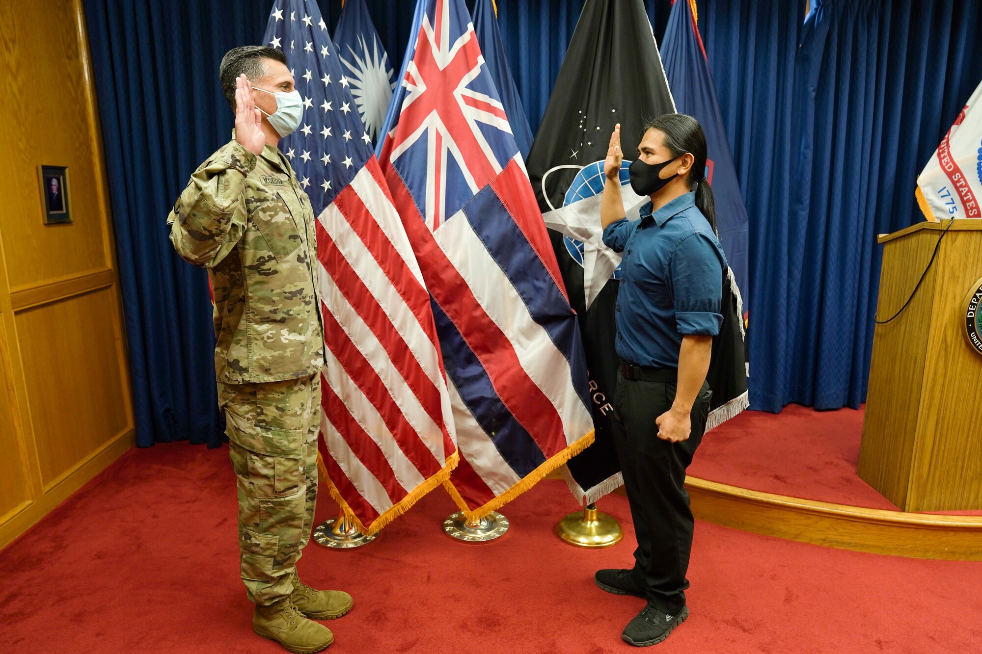 Reyjie Cliff Blando Madriaga, a Hawaiian native, receives the oath of enlistment from U.S. Army Capt. Donald McCoullough, Honolulu Military Entrance Processing Station Officer, as the first Hawaiian U.S. Space Force at Joint Base Pearl Harbor-Hickam, Hawaii, March 4, 2021. The oath of enlistment is a promise made by members of the United States Armed Forces to support and defend the Constitution. (U.S. Air Force photo by Airman 1st Class Makensie Cooper)