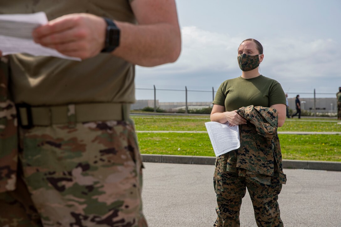 U.S. Marine Corps Staff Sgt. Felicia White, a supply chief with Camp Kinser Post Office, waits in line to receive her second dose of the COVID-19 vaccine at the U.S. Naval Hospital Okinawa, on Camp Foster, Mar. 2, 2021. On Jan. 11, 2021, active duty personnel were permitted to receive the vaccine. As service members receive the second dose of the vaccine, they are given a sticker stating ‘I got my COVID-19 vaccine because…’ This personal memento signifies their own unique reason to receive the vaccine. White is a native to El Paso, Texas. (U.S. Marine Corps photo by Lance Cpl. Zachary Larsen)