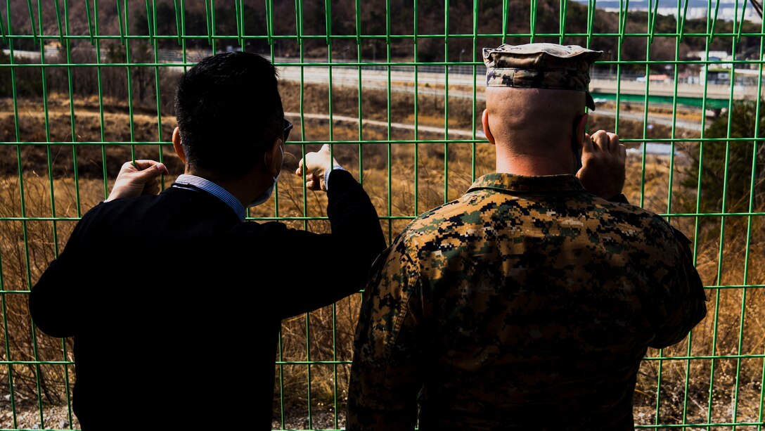 Pyong Yol Kim, left, the combined training liason officer for Camp Mujuk, and U.S. Marine Corps Chief Warrant Officer Four Ryan Josephs, right, the battalion gunner for 3rd Battalion, 3rd Marine Regiment, 3rd Marine Division, observe a trail to be used by Marines with 3rd Battalion, 3rd Marine Regiment for a hike during Korean Marine Exchange Program 21-2 (KMEP 21-2) in Pohang, Republic of Korea (ROK) March 10, 2021. U.S. Marines from 3rd Battalion, 3rd Marine Regiment conducted a site survey with ROK Marines from 2nd Battalion, 3rd Marine Brigade, 1st ROK Marine Division of multiple training areas located around the city of Pohang where KMEP 21-2 will be held. (U.S. Marine Corps photo by Cpl. Ryan H. Pulliam)