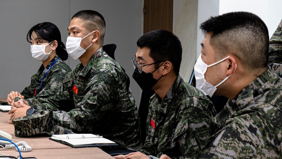 Republic of Korea (ROK) Marines with 2nd Battalion, 3rd Marine Brigade, 1st ROK Marine Division (ROKMARDIV), listen to U.S. Marines from 3rd Battalion, 3rd Marine Regiment, 3rd Marine Division, inquiring about safety prior to a site survey of multiple training areas for Korean Marine Exchange Program 21-2 (KMEP 21-2) at the 1st ROKMARDIV Base, Pohang, ROK March 8, 2021. U.S. Marines from 3rd Battalion, 3rd Marine Regiment conducted a site survey with ROK Marines from 2nd Battalion, 3rd Marine Brigade of multiple training areas located around the city of Pohang where KMEP 21-2 will be held. (U.S. Marine Corps photo by Cpl. Ryan H. Pulliam)