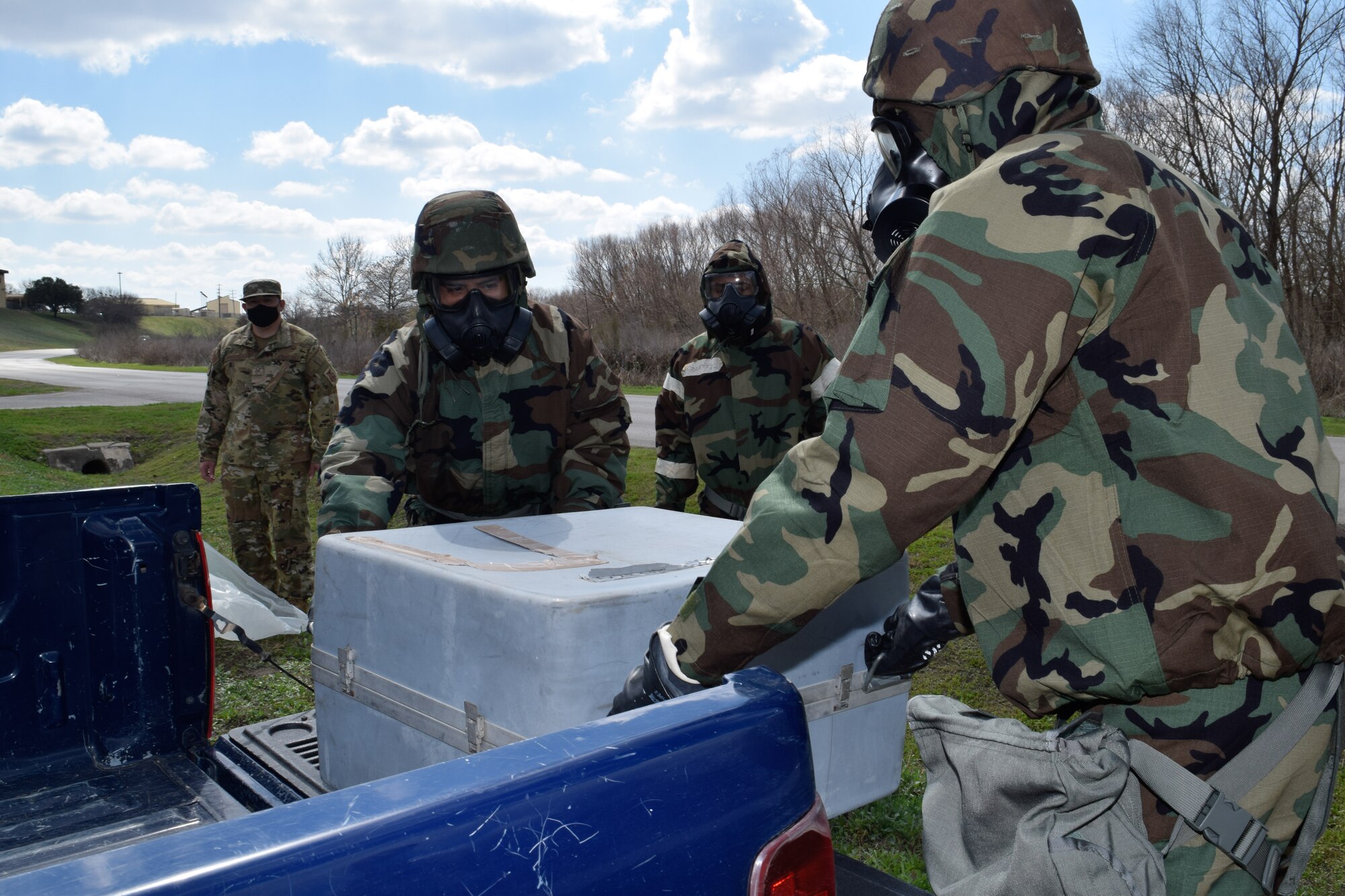 Reserve Citizen Airmen in the 433rd Airlift Wing work together to unload cargo March 6, 2021, at Joint Base San Antonio-Lackland, Texas. The Airmen received real world training and practice in wearing different levels of mission-oriented protective posture gear, while safely covering, uncovering and transporting cargo. (U.S. Air Force photo by Senior Airman Brittany Wich)