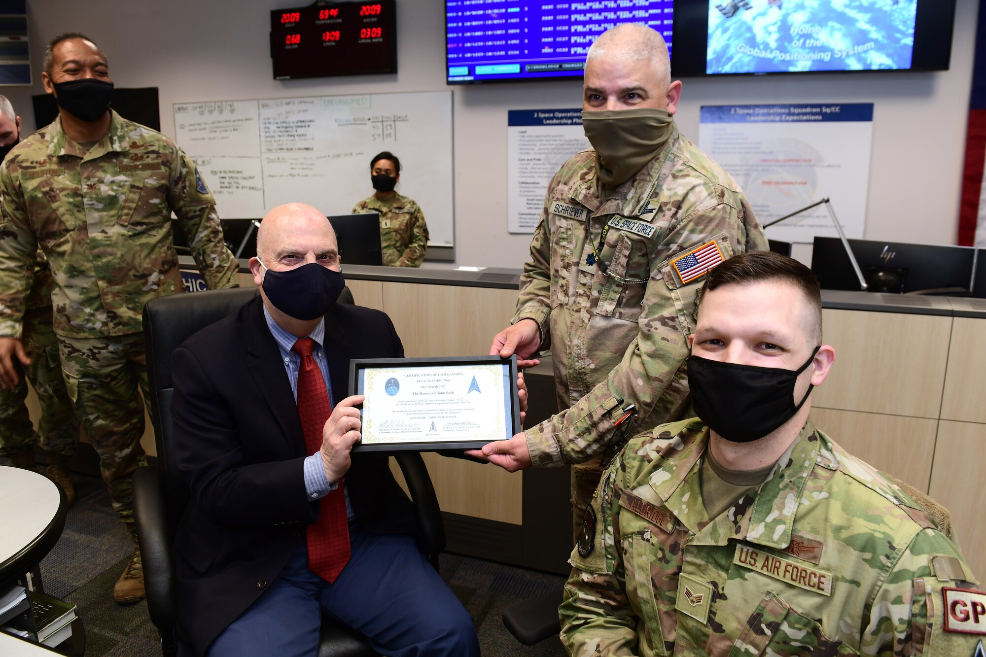 SCHRIEVER AIR FORCE BASE, Colo. – U.S. Space Force Lt. Col. Michael Schriever presents Acting Secretary of the Air Force John P. Roth with a certificate during Roth’s March 9, 2021 visit to Schriever Air Force Base, Colorado. 2nd Space Operations Squadron gave Roth the opportunity to be an active participant in an operations demonstration from U.S. Air Force Senior Airman Connor Aldridge, 2nd Space Operations Squadron space systems operator. (U.S. Space Force photo by Dennis Rogers)