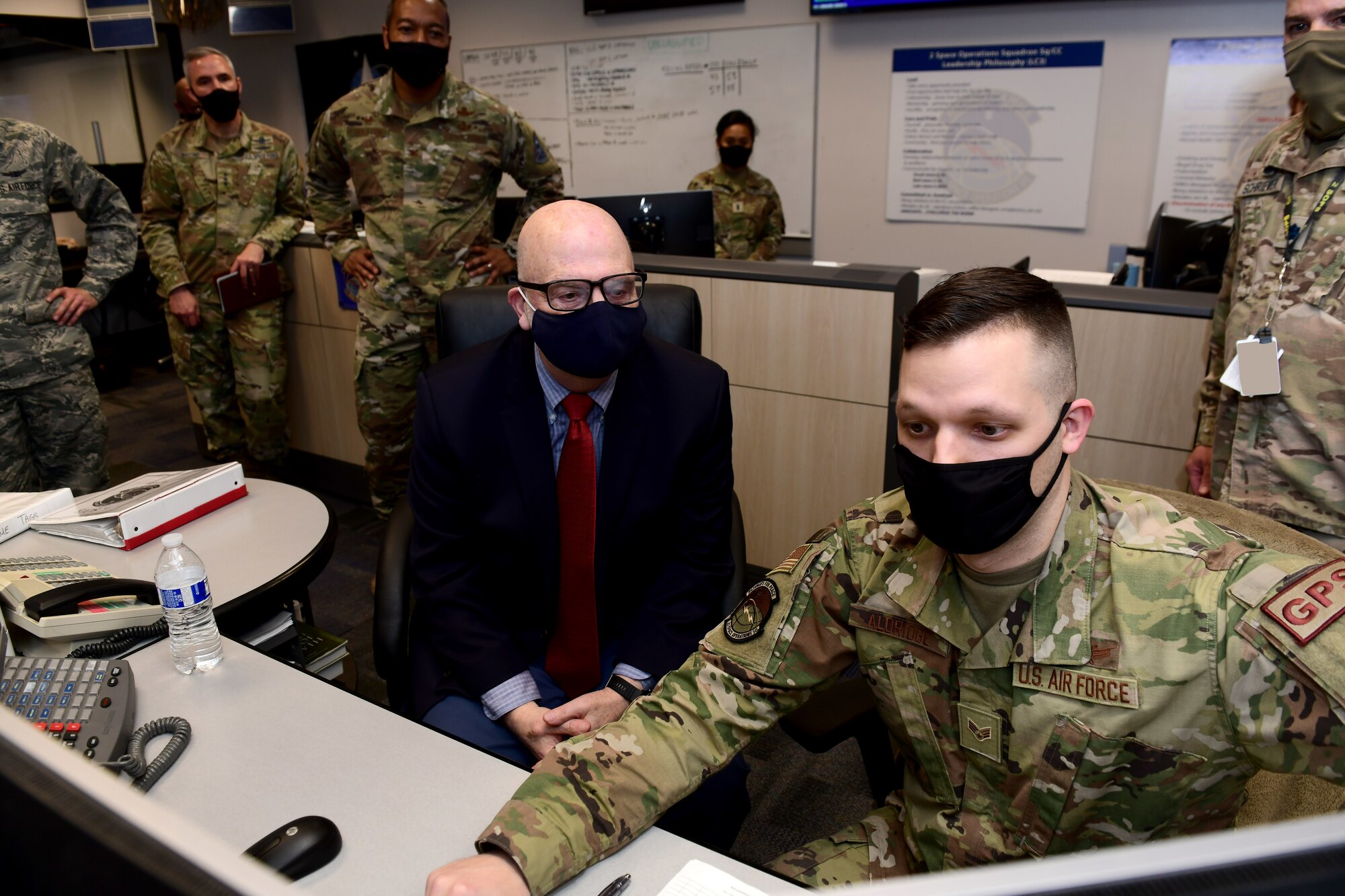SCHRIEVER AIR FORCE BASE, Colo. – Acting Secretary of the Air Force John P. Roth watches as U.S. Air Force Senior Airman Connor Aldridge, 2nd Space Operations Squadron space systems operator, demonstrates some of the unit’s capabilities during Roth’s March 9, 2021 visit to Schriever Air Force Base, Colorado. 2nd SOPS performs the command and control mission for the USSF’s GPS satellite constellation. (U.S. Space Force photo by Dennis Rogers)