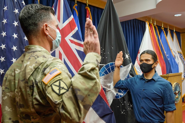 Reyjie Cliff Blando Madriaga, a Hawaiian native, receives the oath of enlistment from U.S. Capt. Donald McCoullough, Honolulu Military Entrance Processing Station Officer, as the first Hawaiian Space Force recruit at Joint Base Pearl Harbor-Hickam, Hawaii, March 4, 2021. The oath of enlistment is a promise made by members of the United States Armed Forces to support and defend the Constitution. (U.S. Air Force photo by Airman 1st Class Makensie Cooper)