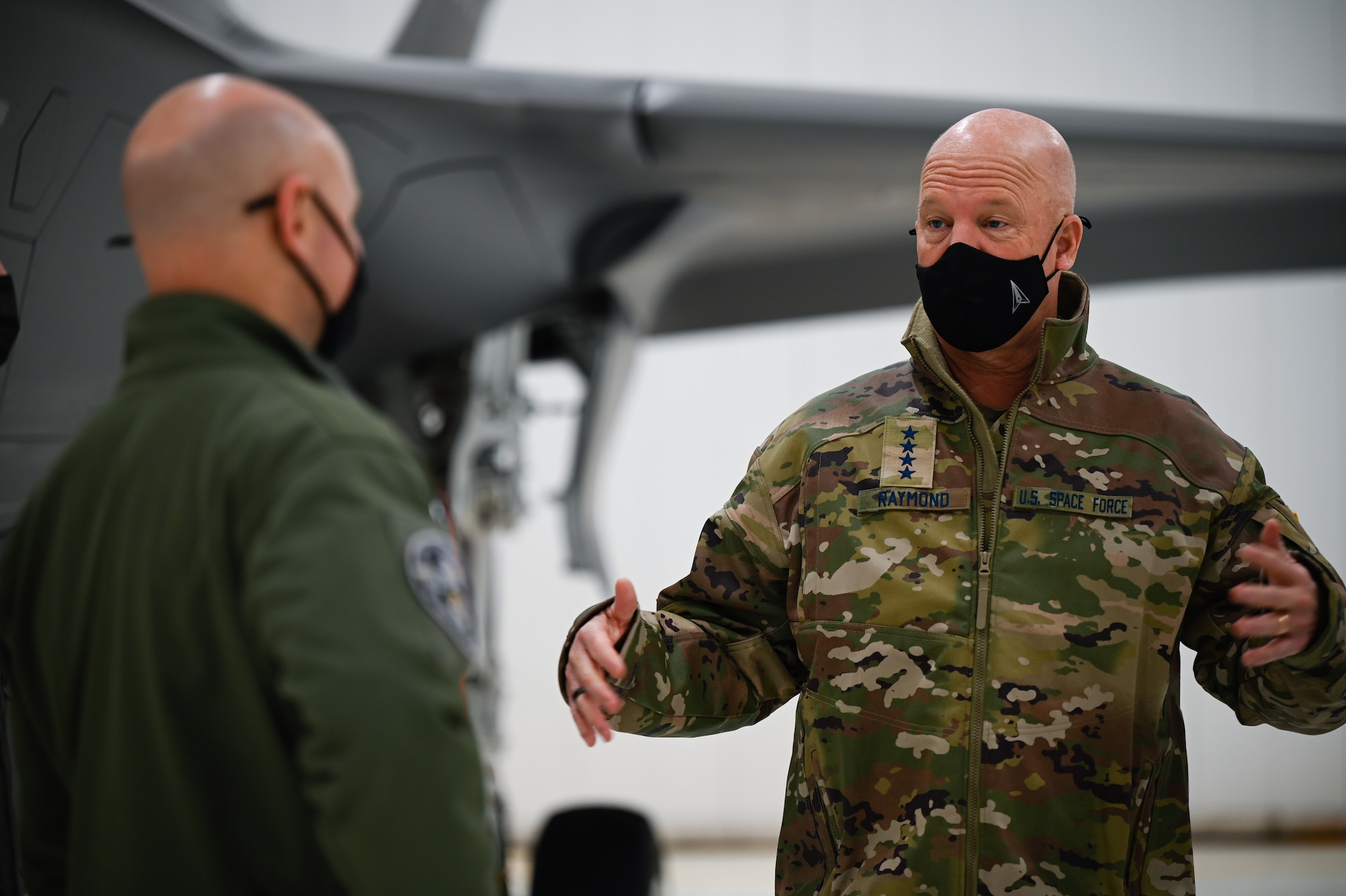 U.S. Air Force Col. David Berkland, the 354th Fighter Wing commander, talks to U.S. Space Force Gen. John W. “Jay” Raymond, Chief of Space Operations, on Eielson Air Force Base, Alaska, March 10, 2021.