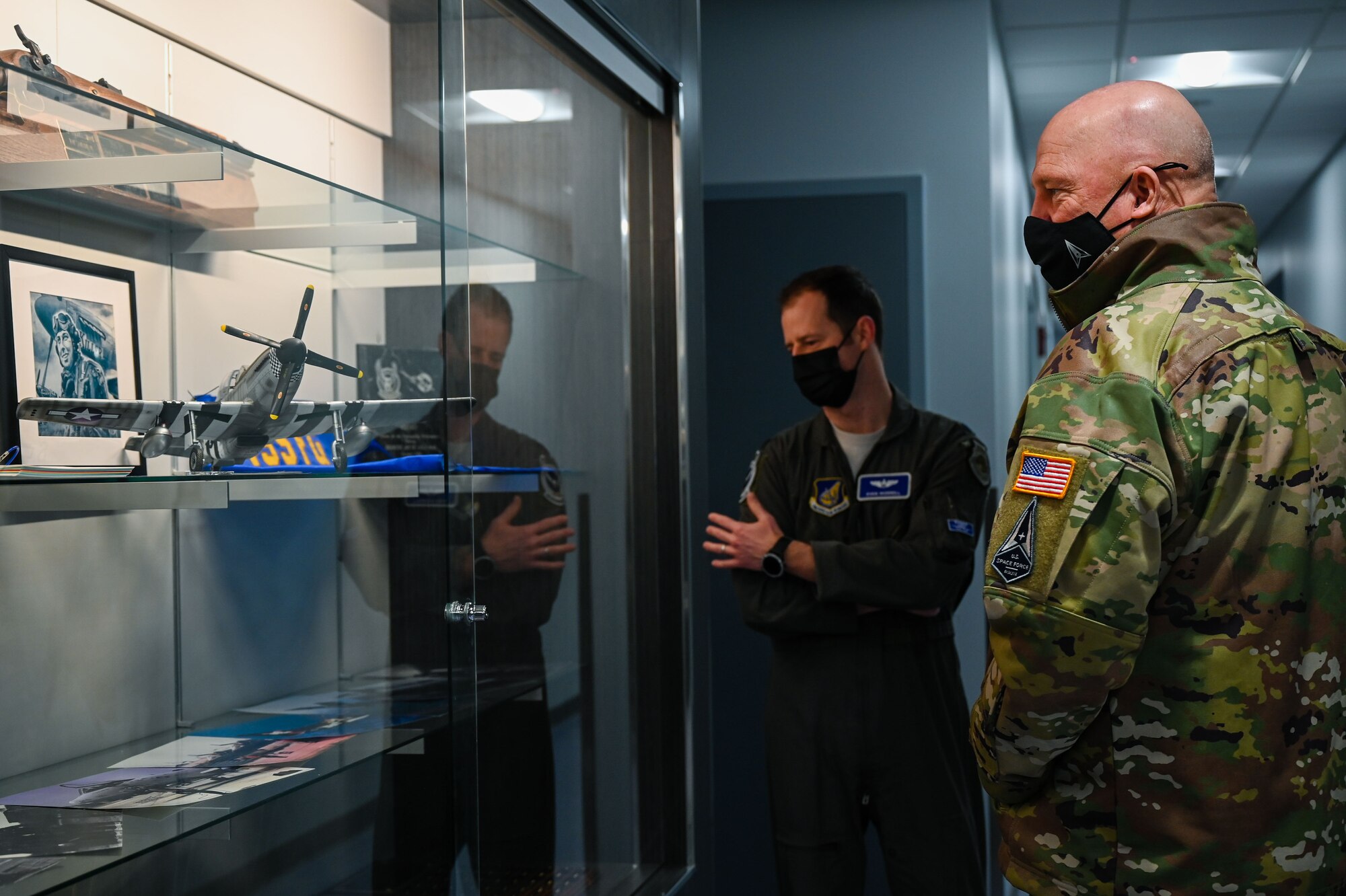 U.S. Air Force Lt. Col. Ryan Worrell, the 355th Fighter Squadron director of operations, and U.S. Space Force Gen. John W. “Jay” Raymond, Chief of Space Operations, look at a heritage display on Eielson Air Force Base, Alaska, March 10, 2021.