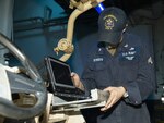 U.S. Navy Hull Technician 2nd Class Dawsen Forbes, a hull technician assigned to amphibious assault ship USS America (LHA 6), and a native of Denver, North Carolina, fits a laptop inside a welded aluminum piece within a light tactical all-terrain vehicle (MRZR) aboard LHA 6 in the Philippine Sea, Jan. 20, 2021. Forbes designed and welded aluminum parts to fit inside the MRZR to help secure radios, laptops and extra equipment during training exercises and operations. (U.S. Marine Corps photo by Cpl. Cody Rowe)