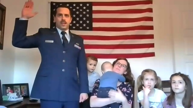 Air Force Research Laboratory exchange officer to the United Kingdom Capt. Jacob Singleton is inducted into the U.S. Space Force Feb. 10, as his wife Mandy and their four children look on. Col. Charles Metrolis, Air Attaché, US Embassy, London administered the oath of office in the virtual event. (Courtesy photo)