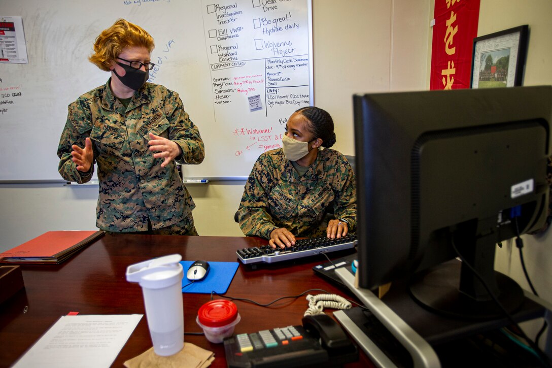 U.S. Marine Corps Sgt. Jerre’al Hayles, a Pacific trial team paralegal, and Lance Cpl. Kaitlin Harms, a regional trial team specialist with the Legal Service Support Section, discuss special notification procedures on Camp Foster, Okinawa, Japan, March 10, 2021. Hayles won the 2020 Trial Service Office Marine of the Year award for going above and beyond the expectations and duties within the unit. Hayles is a native of Smithfield, Virginia and Harms is a native of Paxton, Illinois. (U.S. Marine Corps photo by Cpl. Karis Mattingly)
