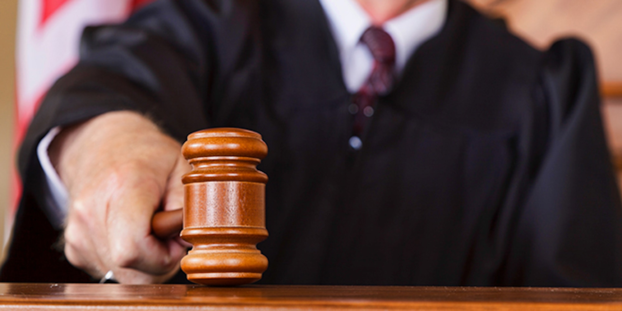 A close-up of a judge's gavel in his hand © iStock.com/RichLegg