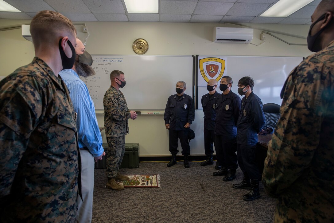 U.S. Marine Corps Col. Matthew Nation, the commanding officer of Headquarters Battalion, 3d Marine Division, gives his remarks to Japanese Security Guards (JSG) on Camp Courtney, Okinawa, Japan, March 10, 2021. JSG was presented with challenge coins to highlight their efforts after protecting the installation by stopping an unauthorized intruding vehicle. (U.S. Marine Corps photo by Lance Cpl. Zachary Larsen)