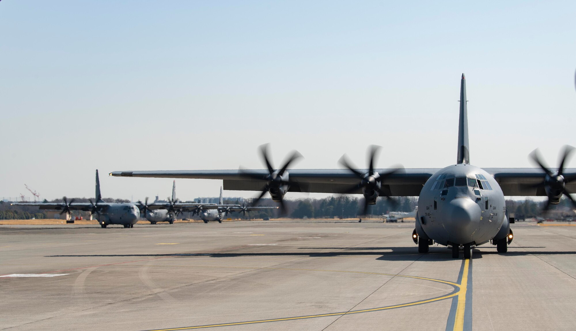 C-130J Super Hercules taxi across the flightline following an equipment airdrop as part of exercise Airborne 21, at Yokota Air Base, Japan, March 11, 2021