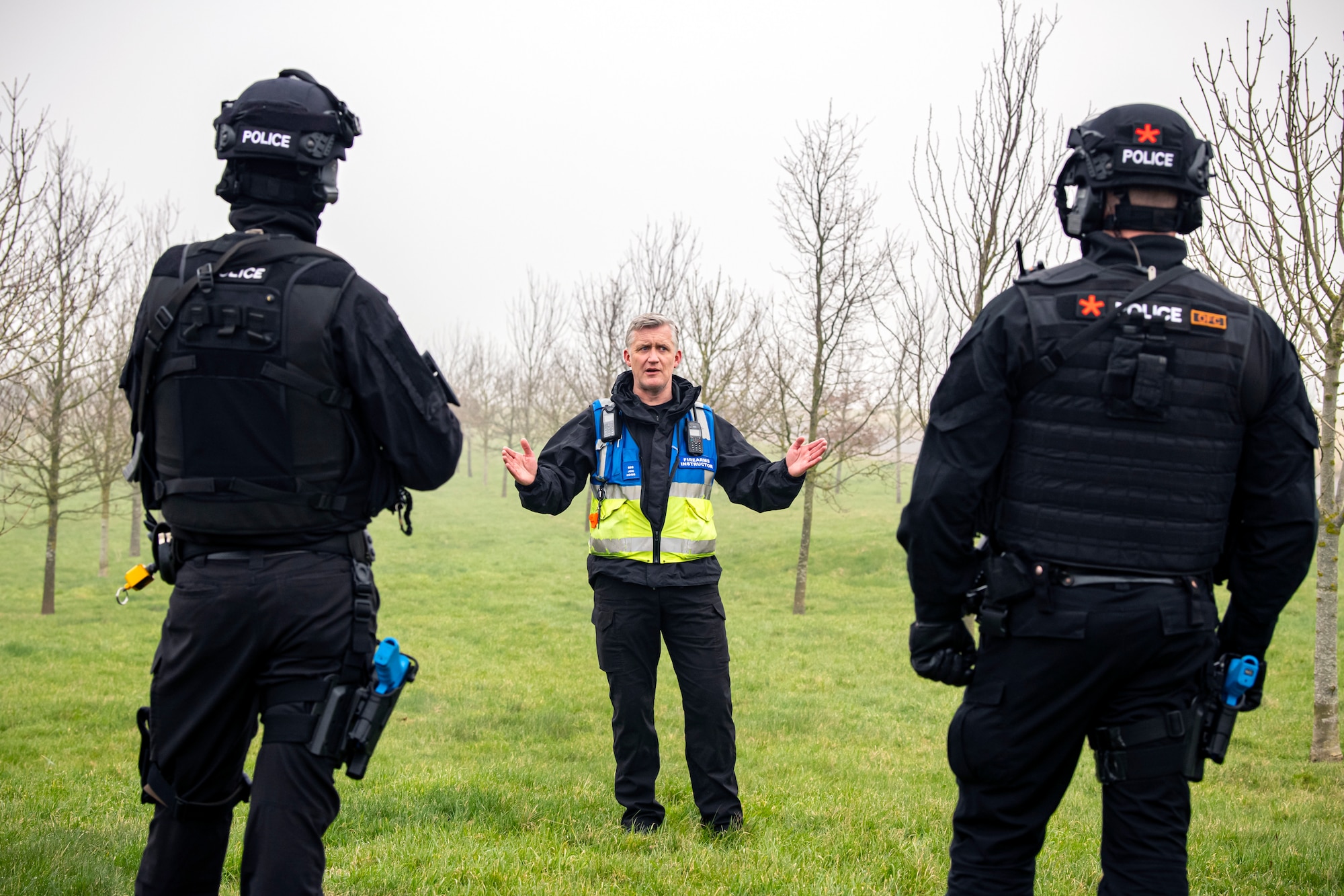 John Hogg, center, Northamptonshire Police Department firearms instructor, briefs policemen from the NHPD prior to a field training exercise at RAF Croughton, England, March 3, 2021. The NHPD utilized the 422d Security Forces Squadron training complex to help strengthen their tactics and techniques. Events like this help strengthen the local partnership between the 422d SFS. (U.S. Air Force photo by Senior Airman Eugene Oliver)