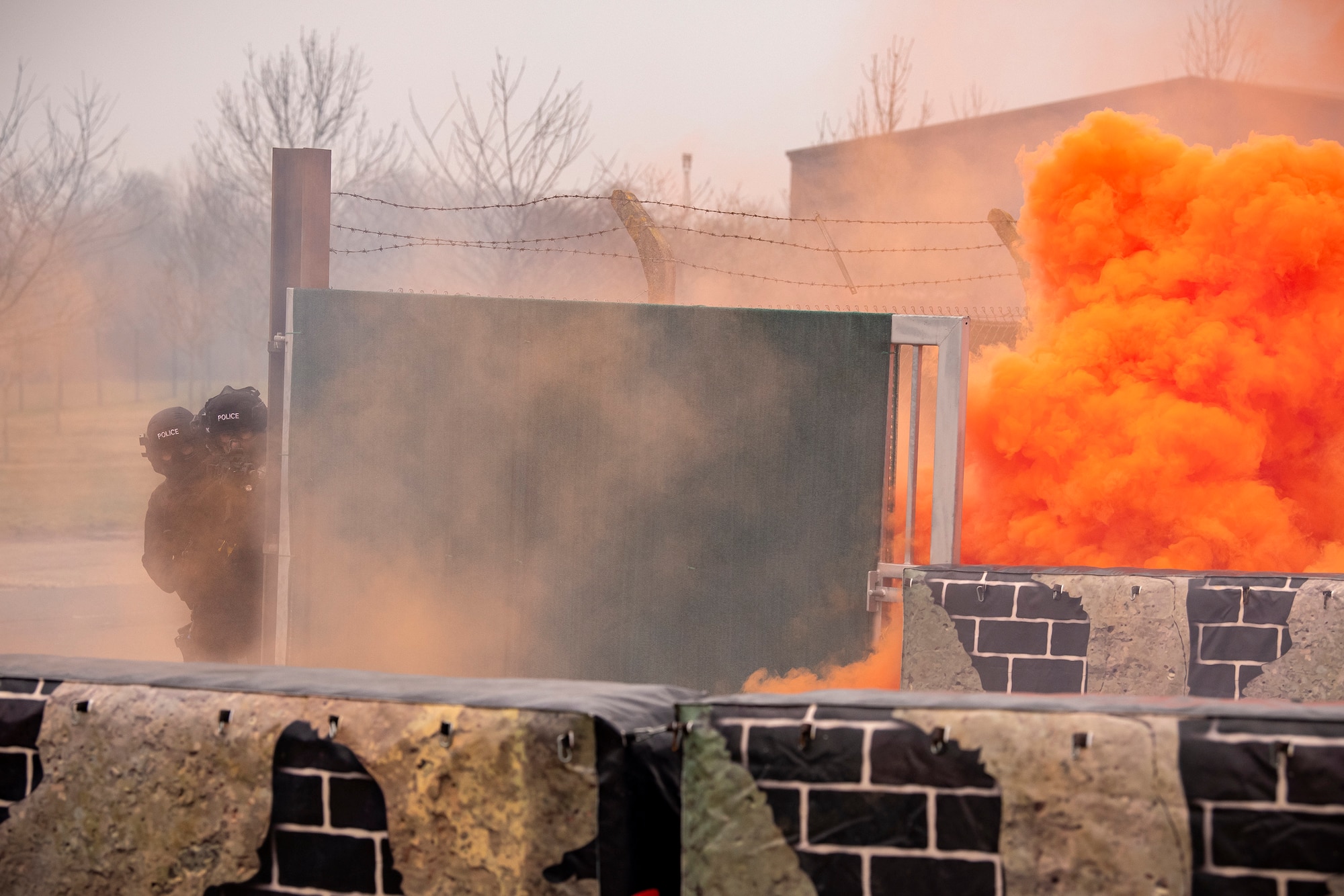 Policemen from the Northamptonshire Police Department, prepare to advance during a field training exercise at RAF Croughton, England, Mar. 3, 2021. The NHPD utilized the 422d Security Forces Squadron training complex to help strengthen their tactics and techniques. Events like this help strengthen the local partnership between the 422d SFS and the NHPD. (U.S. Air Force photo by Senior Airman Eugene Oliver)