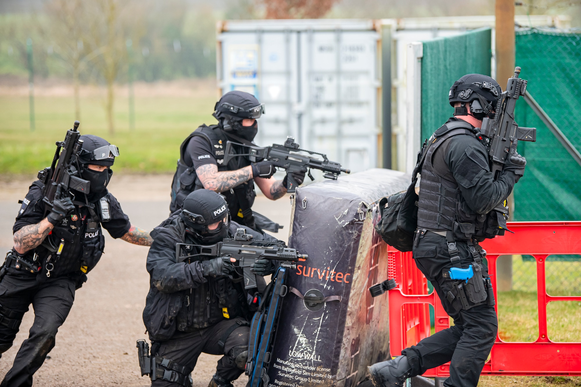 Policemen from the Northamptonshire Police Department, advance their positions during a field training exercise at RAF Croughton, England, Mar. 3, 2021. The NHPD utilized the 422d Security Forces Squadron training complex to help strengthen their tactics and techniques. Events like this help strengthen the local partnership between the 422d SFS and the NHPD. (U.S. Air Force photo by Senior Airman Eugene Oliver)