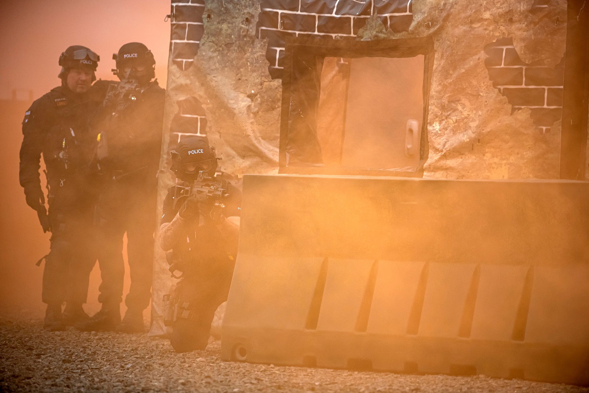 Policemen from the Northamptonshire Police Department, hold their positions during a field training exercise at RAF Croughton, England, Mar. 3, 2021. The NHPD utilized the 422d Security Forces Squadron training complex to help strengthen their tactics and techniques. Events like this help strengthen the local partnership between the 422d SFS and the NHPD. (U.S. Air Force photo by Senior Airman Eugene Oliver)