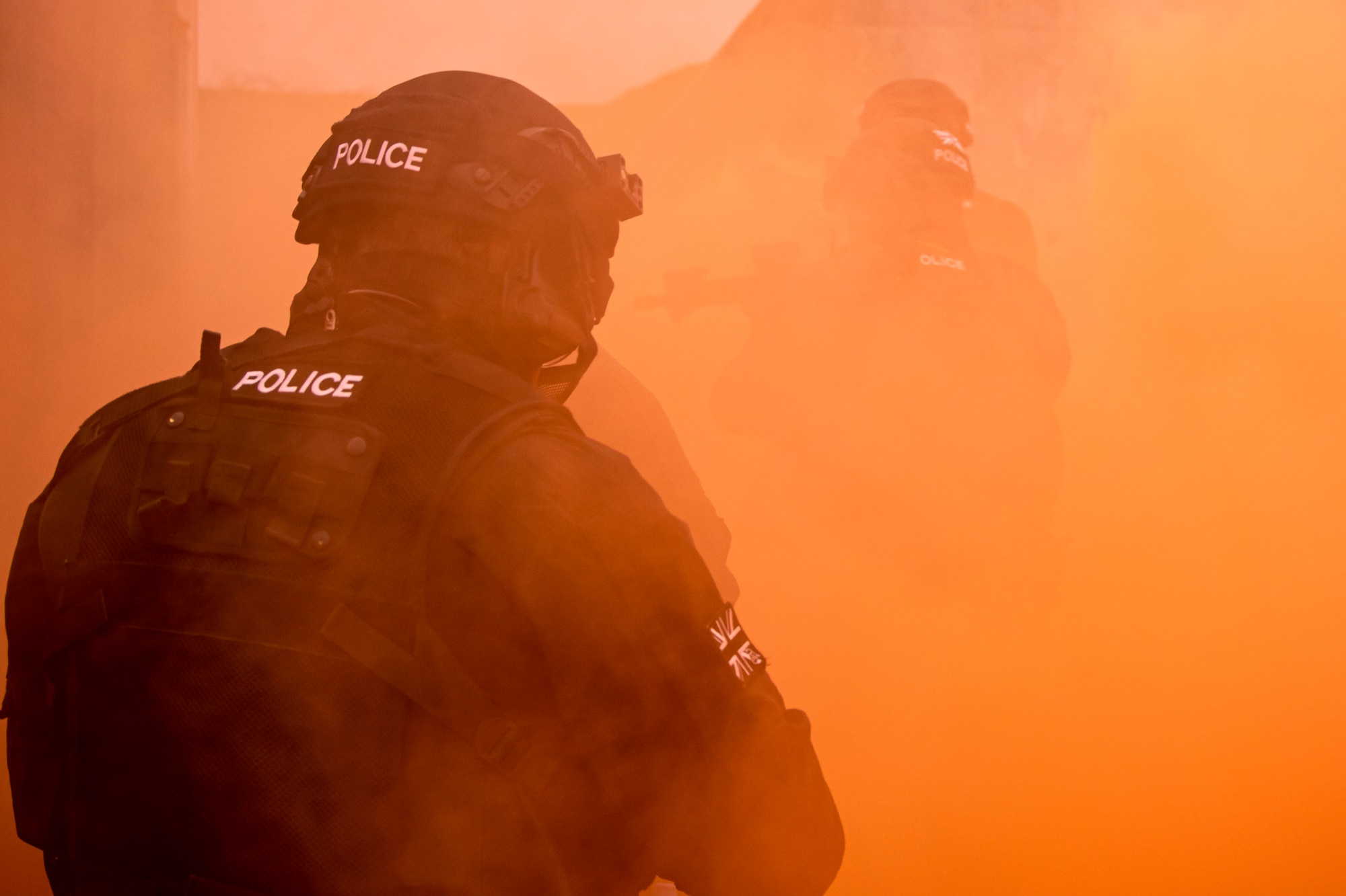 Policemen from the Northamptonshire police department, advance their positions during a field training exercise at RAF Croughton, England, Mar. 3, 2021. The NHPD utilized the 422d Security Forces Squadron training complex to help strengthen their tactics and techniques. Events like this help strengthen the local partnership between the 422d SFS and the NHPD. (U.S. Air Force photo by Senior Airman Eugene Oliver)